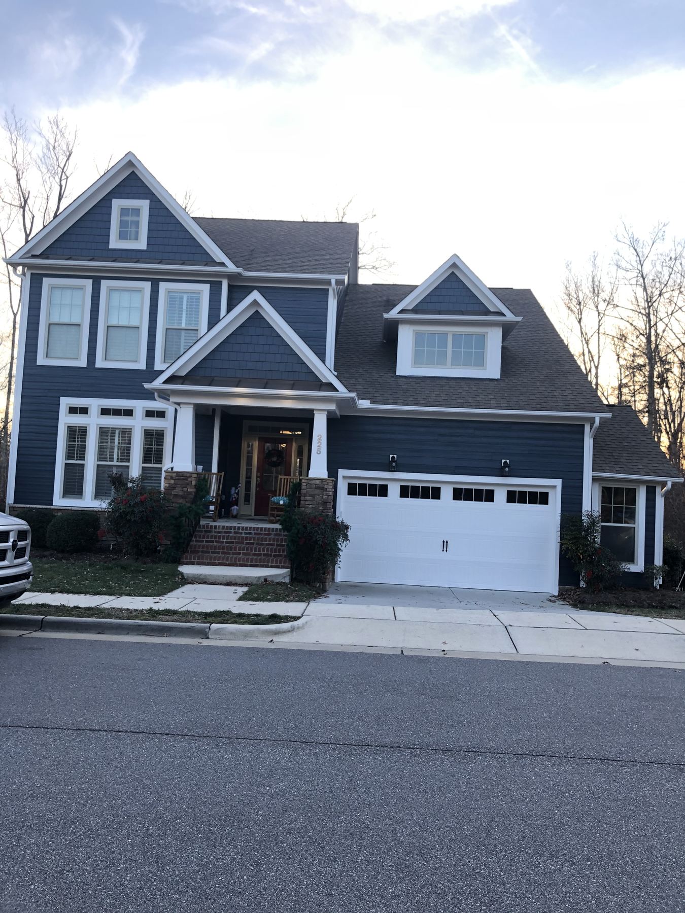 Exterior trim painting in Wendell NC blue house with white trim